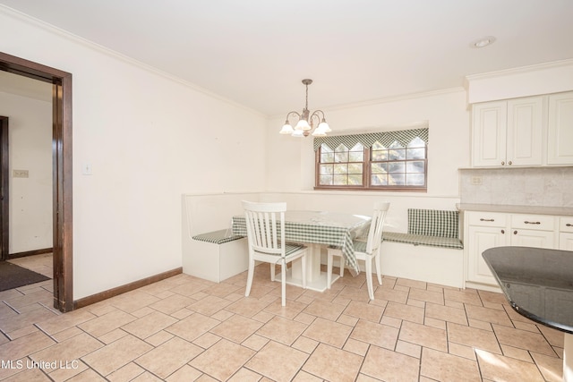 dining room with a notable chandelier and ornamental molding