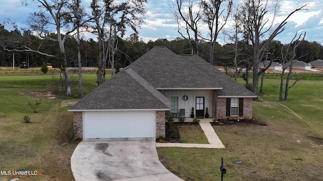 view of front of property with a garage and a front lawn