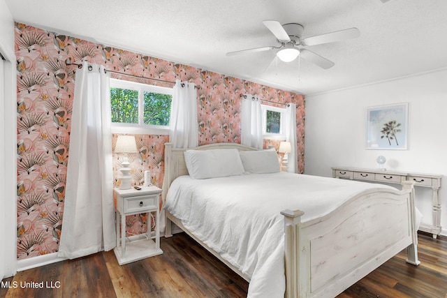 bedroom featuring ceiling fan, dark wood-type flooring, and a textured ceiling