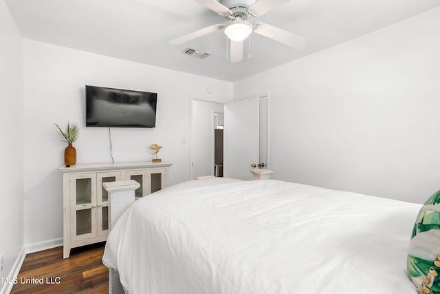 bedroom with dark hardwood / wood-style flooring and ceiling fan