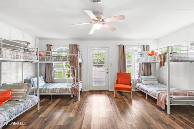 bedroom featuring dark hardwood / wood-style flooring, ceiling fan, and access to exterior