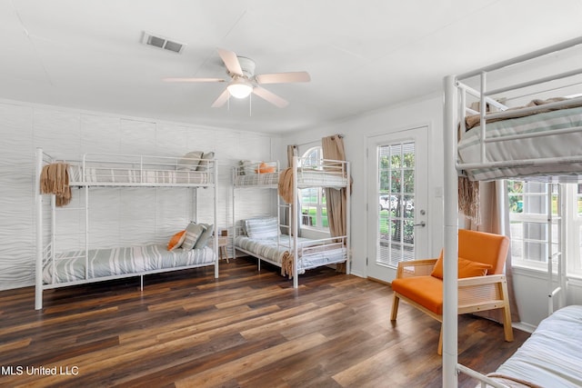 bedroom featuring ceiling fan, dark wood-type flooring, and access to exterior