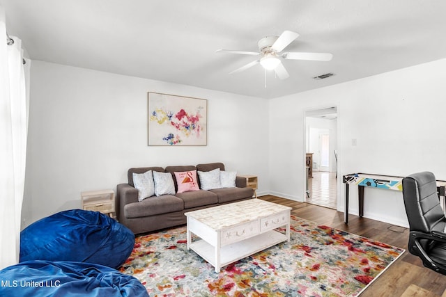 living room featuring ceiling fan and wood-type flooring