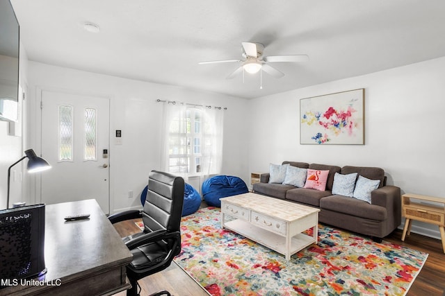 living room with ceiling fan and dark wood-type flooring