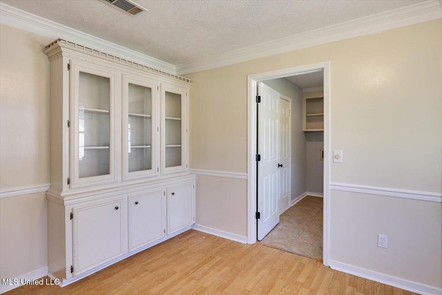 143 Glenwood Dr, Madison, MS 39110 - spare room with light wood finished floors, crown molding, and a textured ceiling