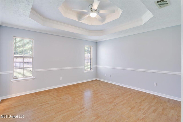 143 Glenwood Dr, Madison, MS 39110 - spare room featuring a tray ceiling, ornamental molding, healthy amount of natural light, wood finished floors, and ceiling fan