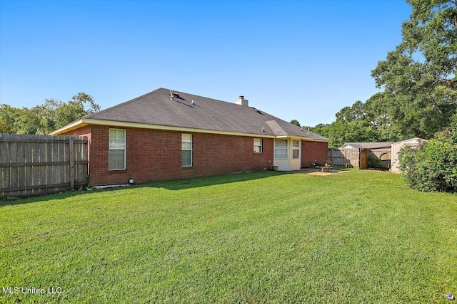 143 Glenwood Dr, Madison, MS 39110 - rear view of house featuring a fenced backyard, brick siding, and a chimney