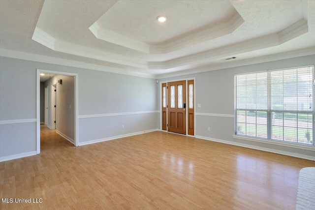 143 Glenwood Dr, Madison, MS 39110 - foyer entrance with ornamental molding, a tray ceiling, light wood-style flooring, and a textured ceiling