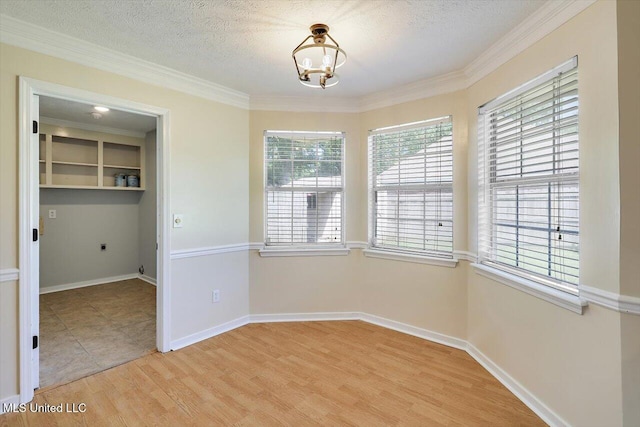 143 Glenwood Dr, Madison, MS 39110 - unfurnished dining area with a chandelier, light wood-style floors, crown molding, and a textured ceiling