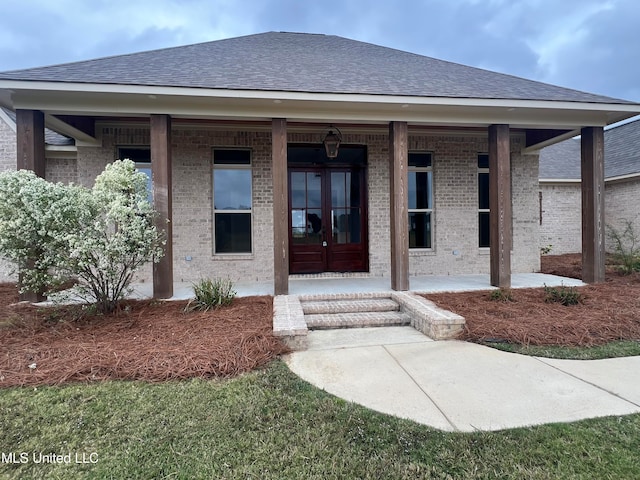 doorway to property featuring french doors and a porch