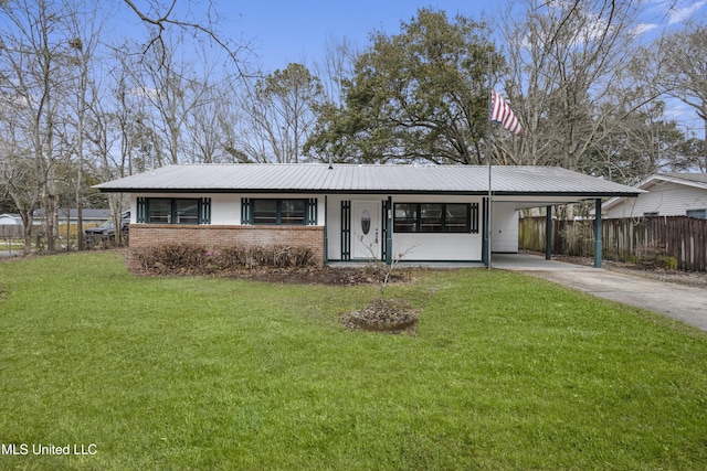 ranch-style home featuring driveway, metal roof, an attached carport, a front lawn, and brick siding