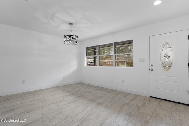 foyer entrance with a chandelier, recessed lighting, and baseboards