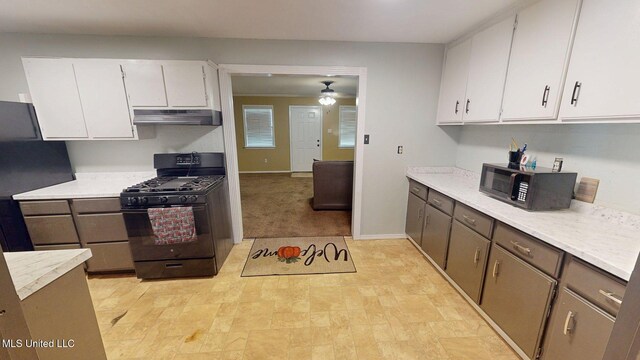 6400 Hans Rd, Moss Point, MS 39562 - kitchen featuring black appliances, under cabinet range hood, white cabinetry, and a ceiling fan