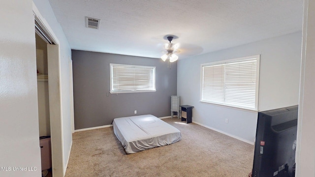 6400 Hans Rd, Moss Point, MS 39562 - bedroom with carpet floors, baseboards, and a ceiling fan