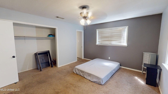 6400 Hans Rd, Moss Point, MS 39562 - bedroom with carpet, a closet, ceiling fan, and baseboards
