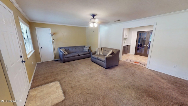 6400 Hans Rd, Moss Point, MS 39562 - living area with ornamental molding, light colored carpet, french doors, a ceiling fan, and baseboards