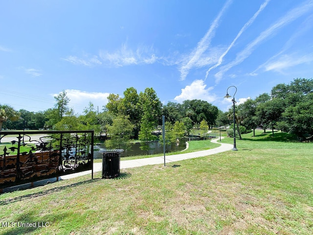 view of community with a yard and a water view