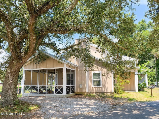 view of front of home with a sunroom