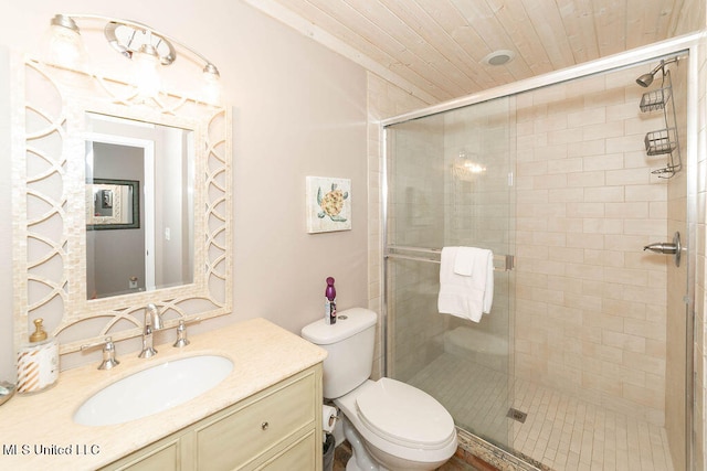 bathroom featuring toilet, an enclosed shower, and vanity