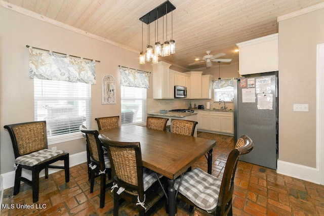 dining area with crown molding, sink, wooden ceiling, and ceiling fan