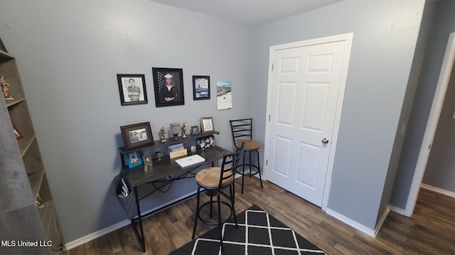 home office featuring dark wood-style flooring and baseboards