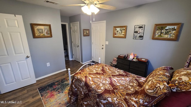 bedroom featuring ceiling fan, wood finished floors, visible vents, and baseboards