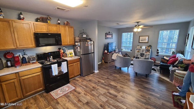 kitchen featuring black appliances, plenty of natural light, visible vents, and light countertops