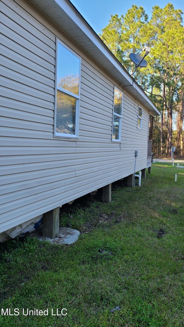 view of property exterior featuring a lawn