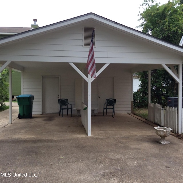 exterior space with a carport and wood walls