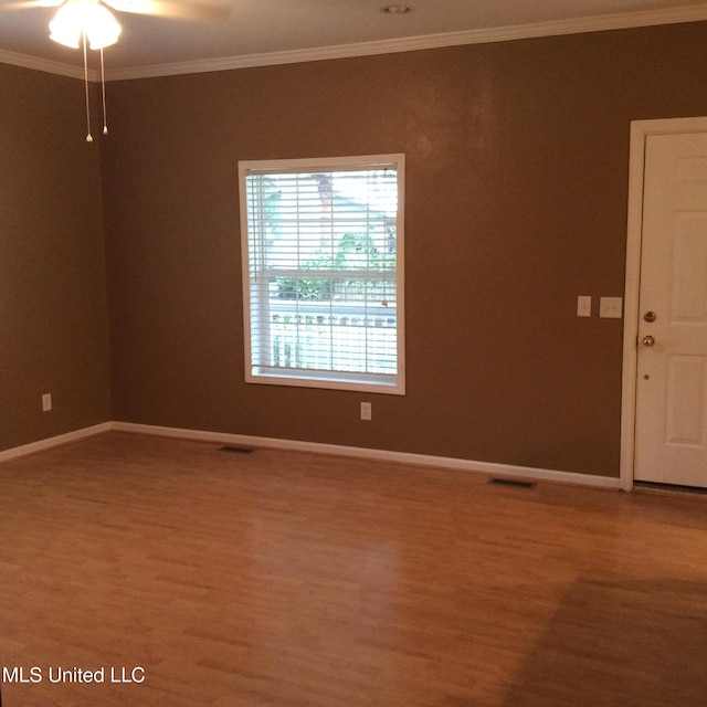 unfurnished room with ornamental molding, hardwood / wood-style flooring, and ceiling fan