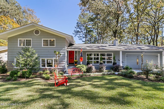 split level home with a front lawn and a garage