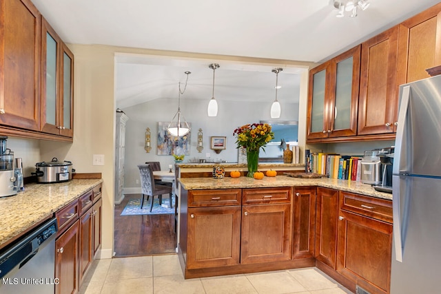 kitchen with light stone countertops, appliances with stainless steel finishes, light wood-type flooring, lofted ceiling, and decorative light fixtures