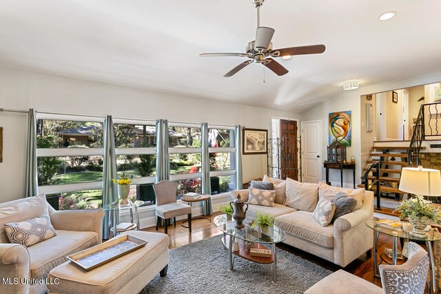 living room featuring lofted ceiling, hardwood / wood-style floors, and ceiling fan