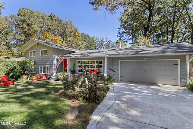 view of front of property with a front yard and a garage