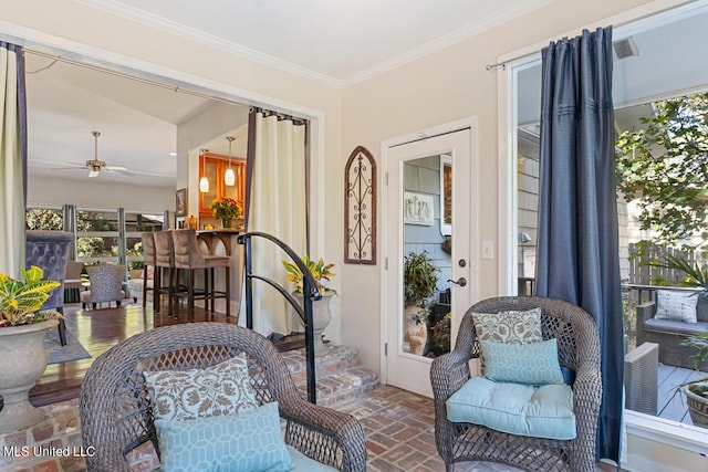 sunroom / solarium featuring ceiling fan