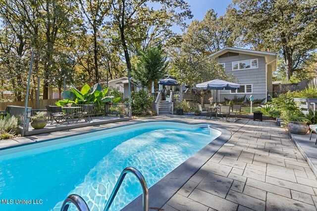 view of swimming pool with a patio