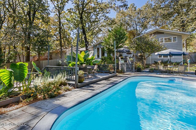 view of swimming pool with a patio area