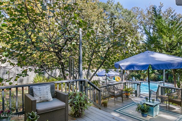 wooden deck featuring a fenced in pool