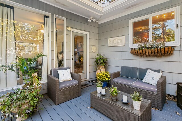 wooden terrace with outdoor lounge area