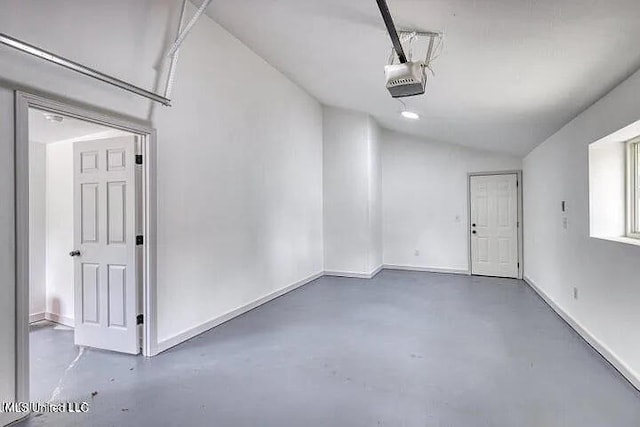 garage with baseboards and a garage door opener