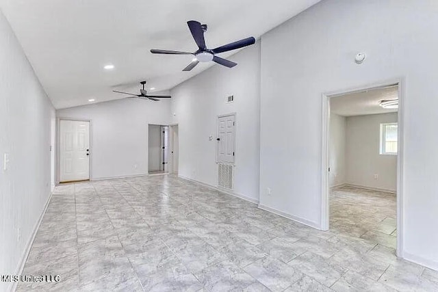 empty room with baseboards, high vaulted ceiling, and a ceiling fan