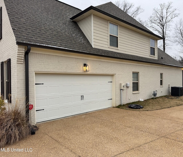 view of property exterior featuring a garage and central AC unit