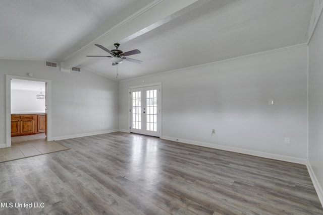 spare room featuring light hardwood / wood-style flooring, french doors, ceiling fan, crown molding, and lofted ceiling with beams