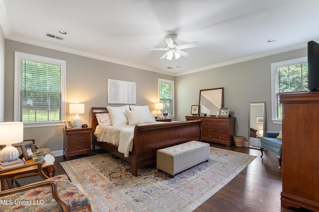bedroom with wood finished floors, crown molding, and a ceiling fan