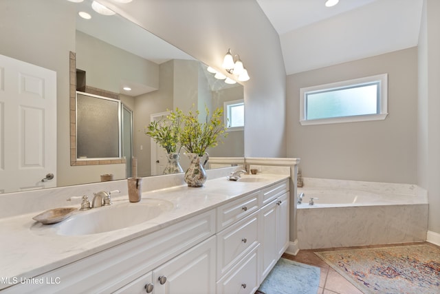 2038 Nottaway Dr, Southaven, MS 38672 - full bathroom featuring a shower stall, a bath, double vanity, lofted ceiling, and tile patterned floors
