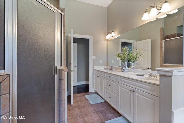 bathroom featuring a shower stall, double vanity, tile patterned flooring, and a chandelier