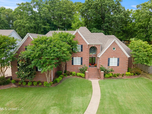 2038 Nottaway Dr, Southaven, MS 38672 - colonial-style house with a front lawn and brick siding