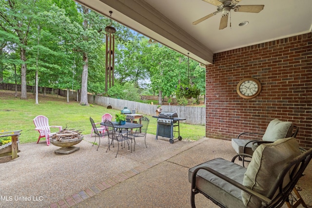 view of patio featuring a fire pit, a grill, ceiling fan, and outdoor dining space