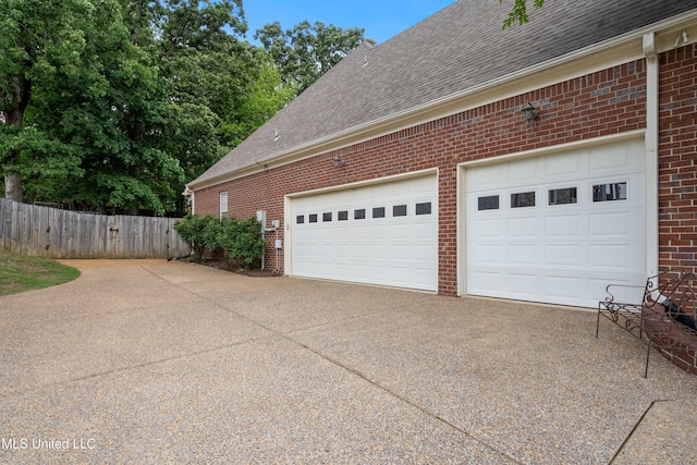 2038 Nottaway Dr, Southaven, MS 38672 - view of property exterior featuring concrete driveway, brick siding, a shingled roof, and fence