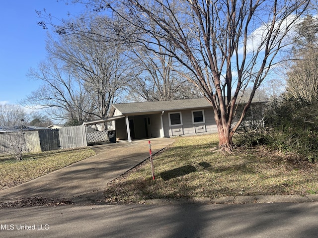 view of front of home with a front lawn and a carport